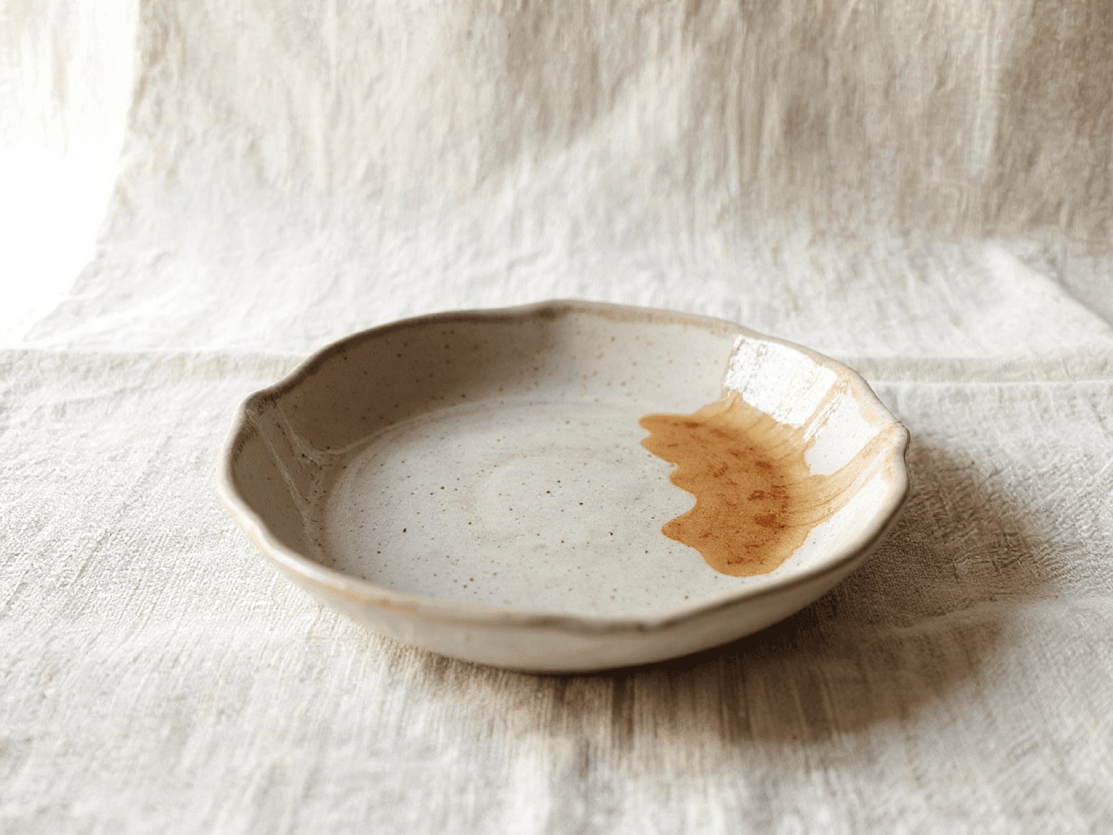 Handmade stoneware dinner plate with a gently irregular rim