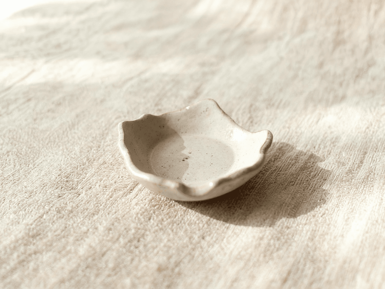 Small stoneware spoon rest with gently pinched edges