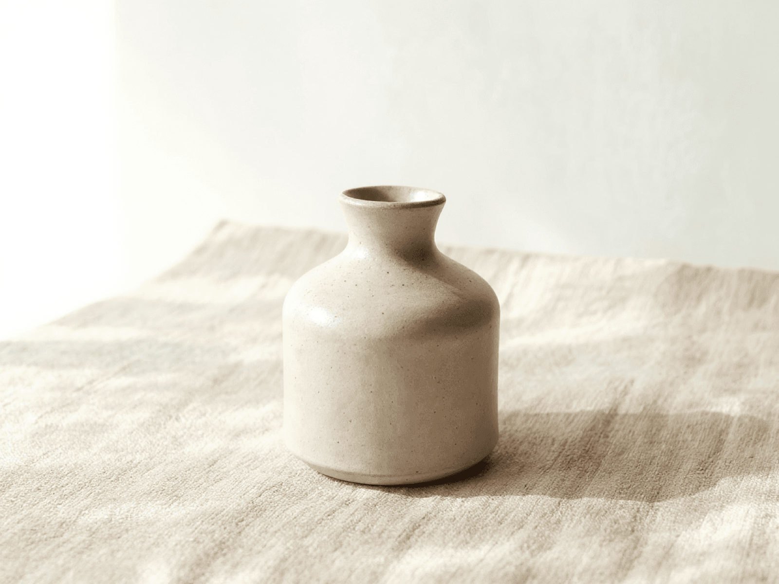 Small matte stoneware bud vase with a narrow neck